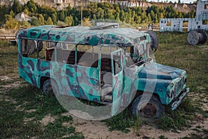 old abandoned bus green in the field