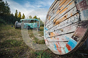 old abandoned bus green in the field