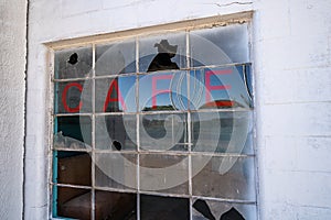 Old abandoned Cafe sign on a broken, busted window, in the Glenrio, Texas ghost town along Route 66 photo