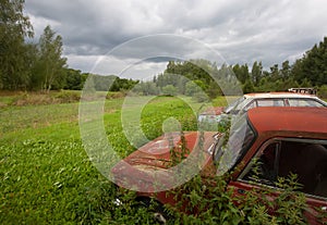 Old abandoned car on the rural field