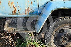 An old abandoned car. Rusty and worn out cab of an old truck