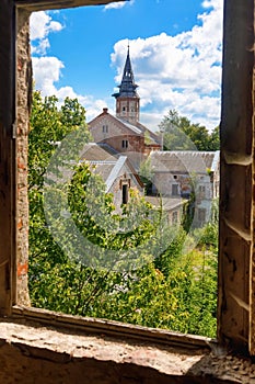 Old abandoned Catholic Church overgrown with greenery