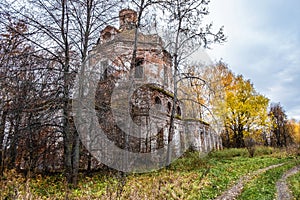 An old abandoned church among autumn yellow trees