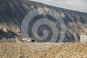 Old abandoned coal wagons, used for the coal mining industry, mountain background Longyear valley, Svalbard Norway