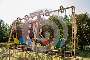 Old abandoned colorful attractions in park in day under sunshine