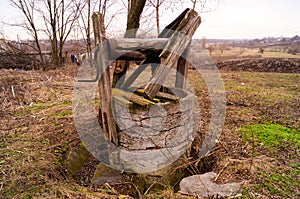 Old, abandoned and destroyed well. Abandoned source in the village.