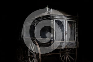 Old abandoned and dusty hearse carriage