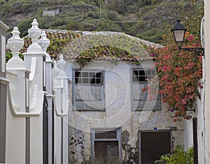 Old abandoned fading aged house in colonial style with roof cove