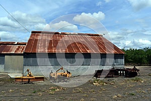 old abandoned farm building with red roof