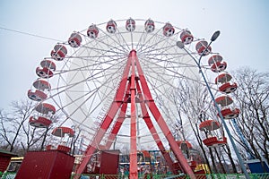 Old abandoned ferris wheel. Attractions closed for the winter