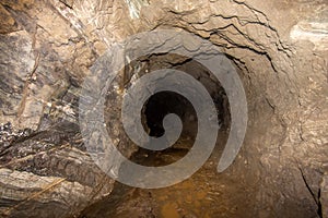 Old abandoned gold mine underground tunnel.