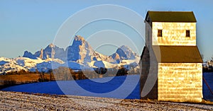 Old Abandoned Grainary Grainery Building with Tetons Teton Mountains in Background