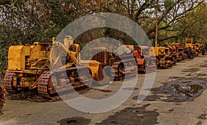 Old and abandoned heavy equipment amongst trees in a rural setting