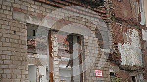 Old abandoned house with collapsed walls. Clip. Abandoned residential building with no windows. Ruins of old residential