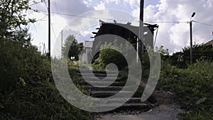 Old abandoned house with collapsed walls. Clip. Abandoned residential building with no windows. Ruins of old residential