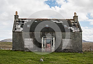 Old abandoned house in the countryside with broken roof