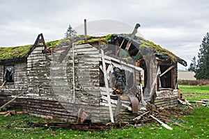 Old abandoned house in disrepair on cold fall day photo