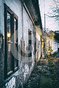 Old abandoned house in the evening light, analog filter