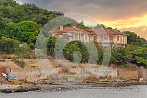 Old abandoned house at the hills of Kinaliada island in Marmara Sea, with dense trees, at sunrise, Istanbul, Turkey