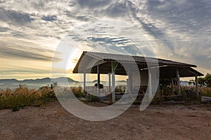 Old abandoned house at the mountain over sunrise in the morning fog