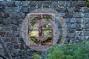 Old and abandoned house overgrown with vegetation