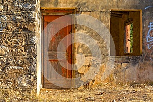 Old, abandoned house with a red door