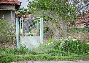 Old abandoned house, with rusty door and number nine sign, rural live, small village street