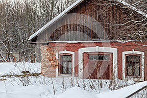 Old  abandoned house with a wooden roof  covered with snow