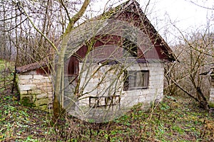 Old abandoned hut, overgrown grass and crest