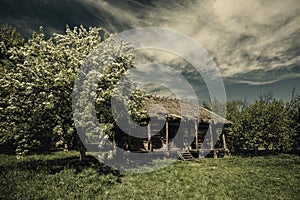 Old abandoned hut under dramatic skies