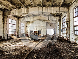 Old abandoned industrial building. Wet, mold damaged, dilapidated reinforced concrete building structures.