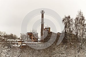 Old abandoned industrial factory building. Ruined historic building. Chimney pipe