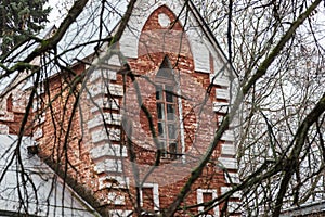 Old abandoned manor house in autumn forest.