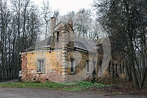 Old abandoned manor house in autumn forest.