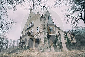 Old abandoned mansion in mystic spooky forest