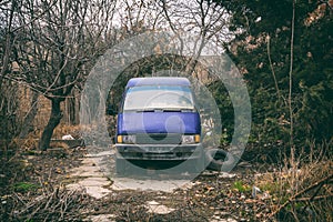 Old abandoned minibus in yard
