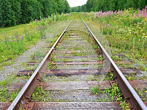 Old abandoned railway in a green field