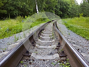 Old Abandoned railway track disappearing into woods