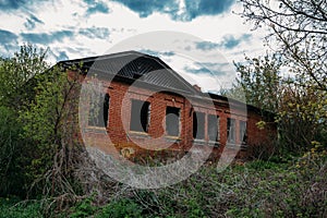 Old abandoned red brick building. Former rural school