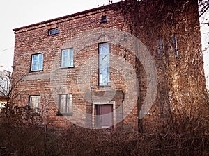 Old abandoned red brick house facade decay abstract