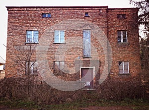 Old abandoned red brick house facade decay abstract