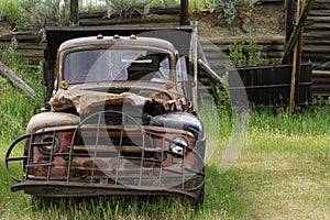 old abandoned red truck in a field