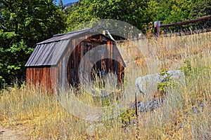 Old abandoned red wood cabin on Hamongog hiking trail below Lone Peak, Wasatch Mountains, Utah.