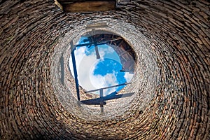 An old abandoned round brick water tower. Inside view