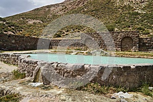 Wellness pool fed by a sulfur spring at old abandoned ruins of a Hotel at the Termas del Sosneado photo