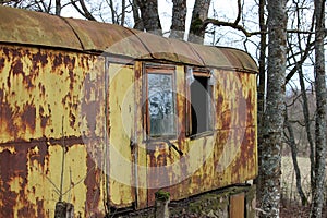 Old abandoned rusted vagon house property in a forest