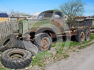 Old abandoned rusty military truck on the side of the road