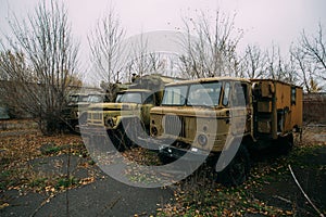 Old abandoned rusty military trucks at the base