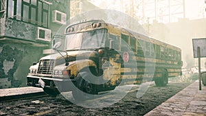 An old abandoned rusty school bus stands in the middle of the road in a deserted city. The image for historical, retro
