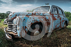 Old abandoned rusty vehicle, forgotten retro car